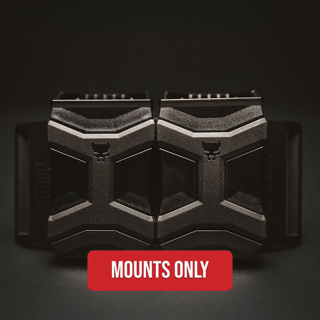 Two black tactical-style pistol magazine mounting brackets shown side by side on a dark background, with a red label at the bottom reading 'MOUNTS ONLY'.